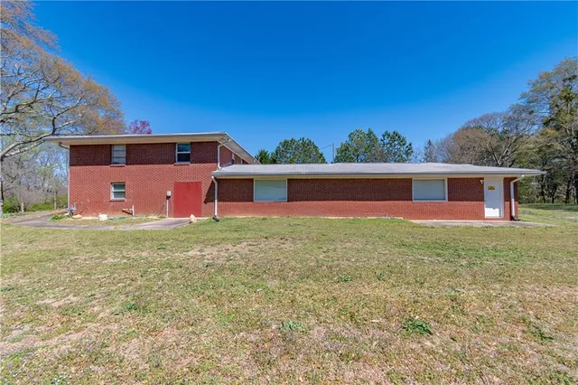 a view of a house with a yard and sitting area