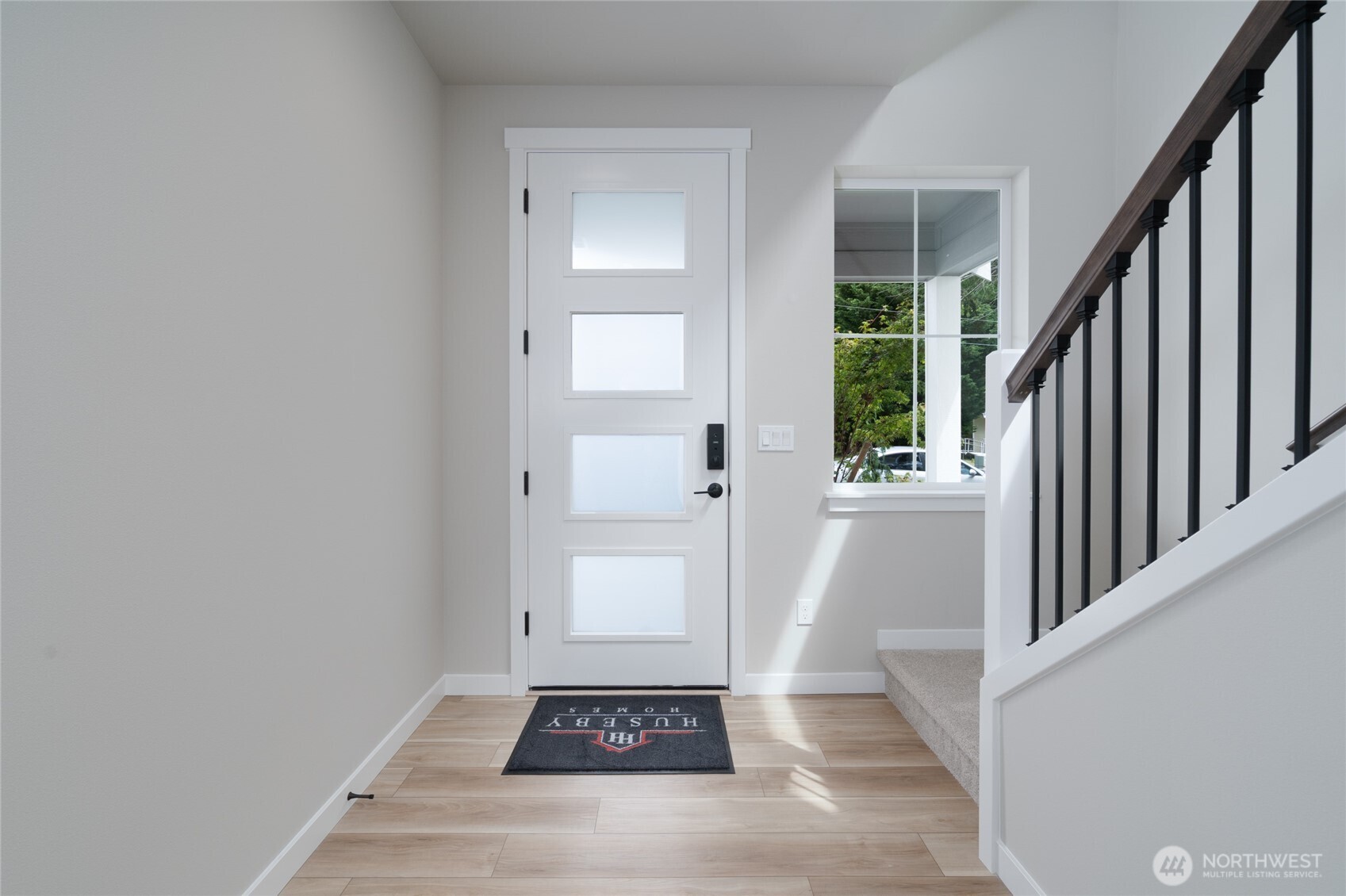 2452 Ridgeway Drive Oak Harbor, WA 98277 - Photo 8 of 10 a view of a hallway with wooden floor and staircase