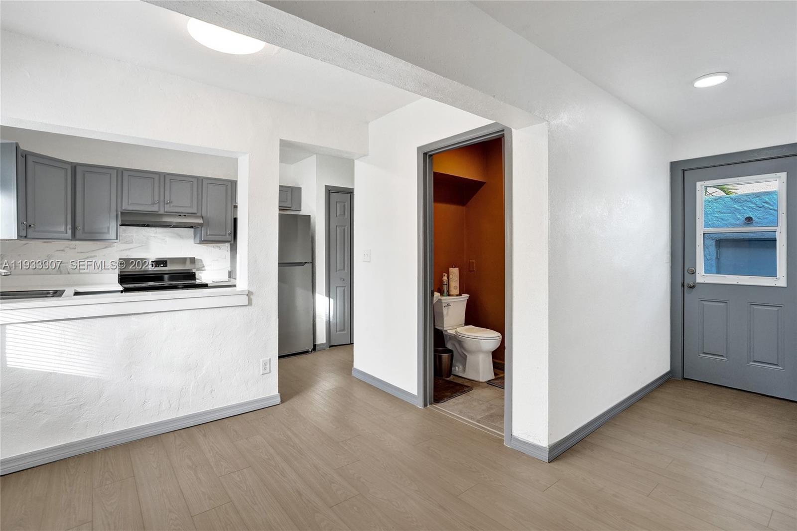 249 Southwest 4th Street, Unit 2 Dania Beach, FL 33004 - Photo 11 of 26 a kitchen with a refrigerator and white cabinets
