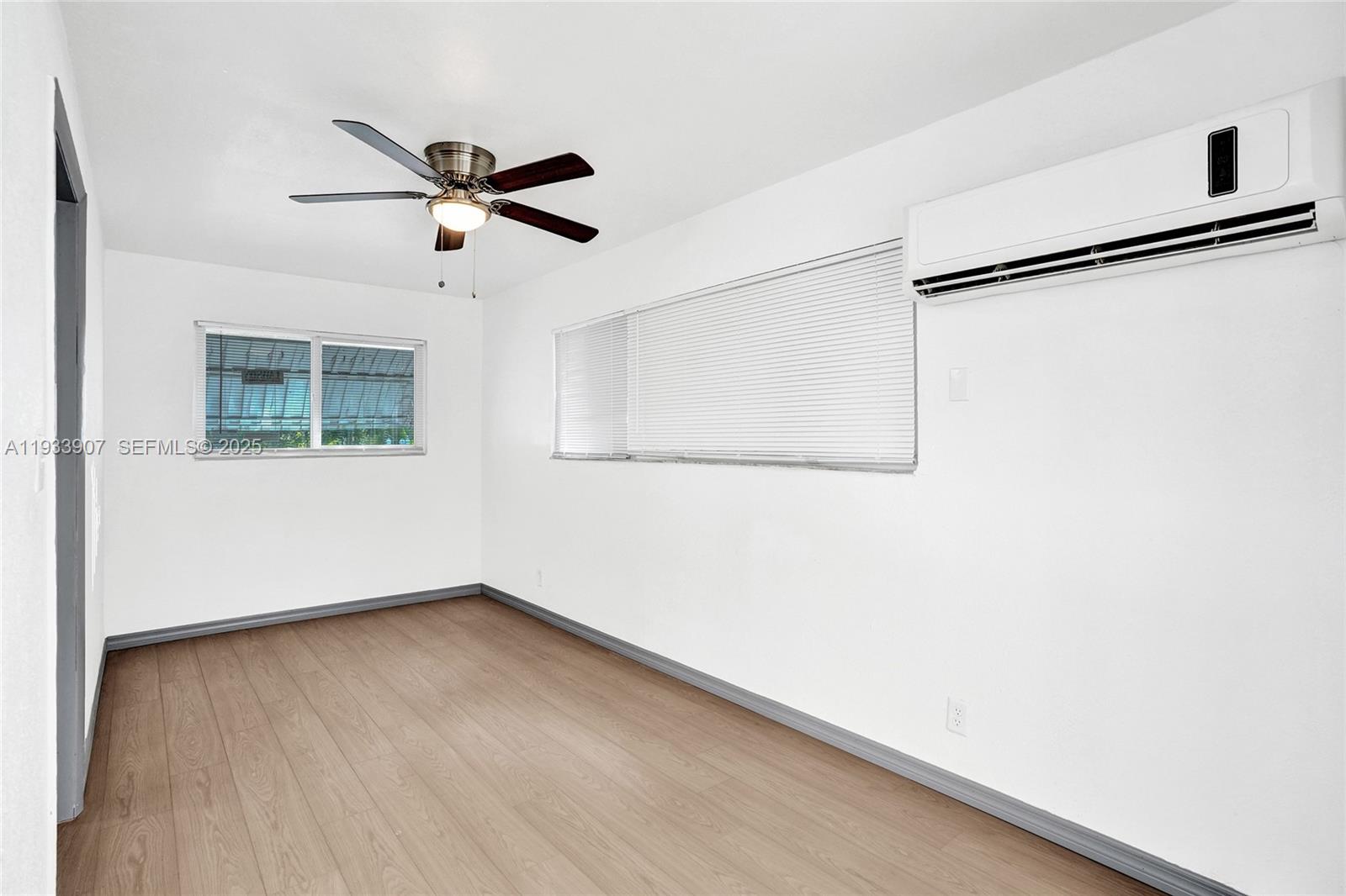 249 Southwest 4th Street, Unit 2 Dania Beach, FL 33004 - Photo 13 of 26 an empty room with a window and a ceiling fan