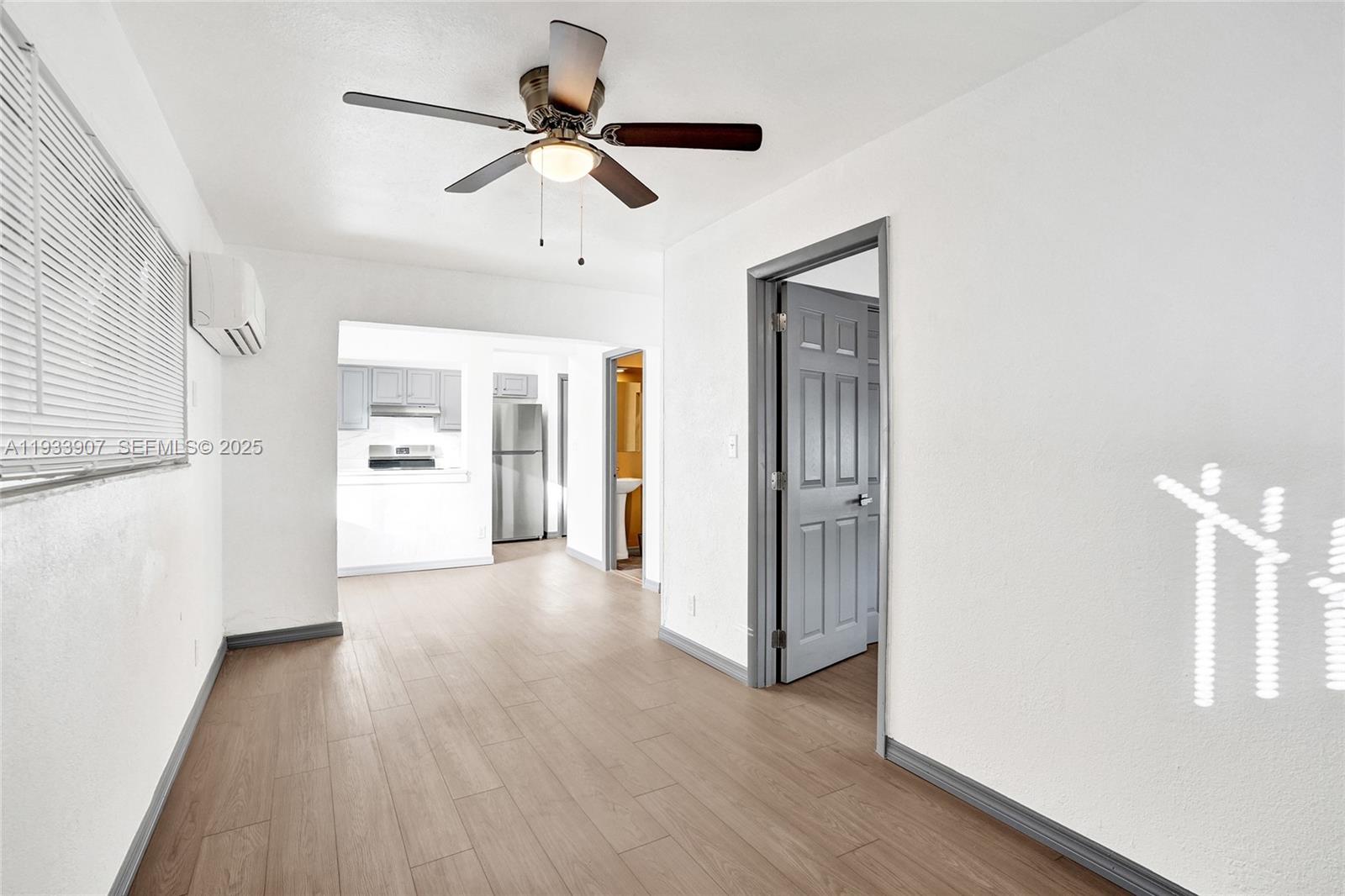 249 Southwest 4th Street, Unit 2 Dania Beach, FL 33004 - Photo 14 of 26 a view of a livingroom with wooden floor and a ceiling fan