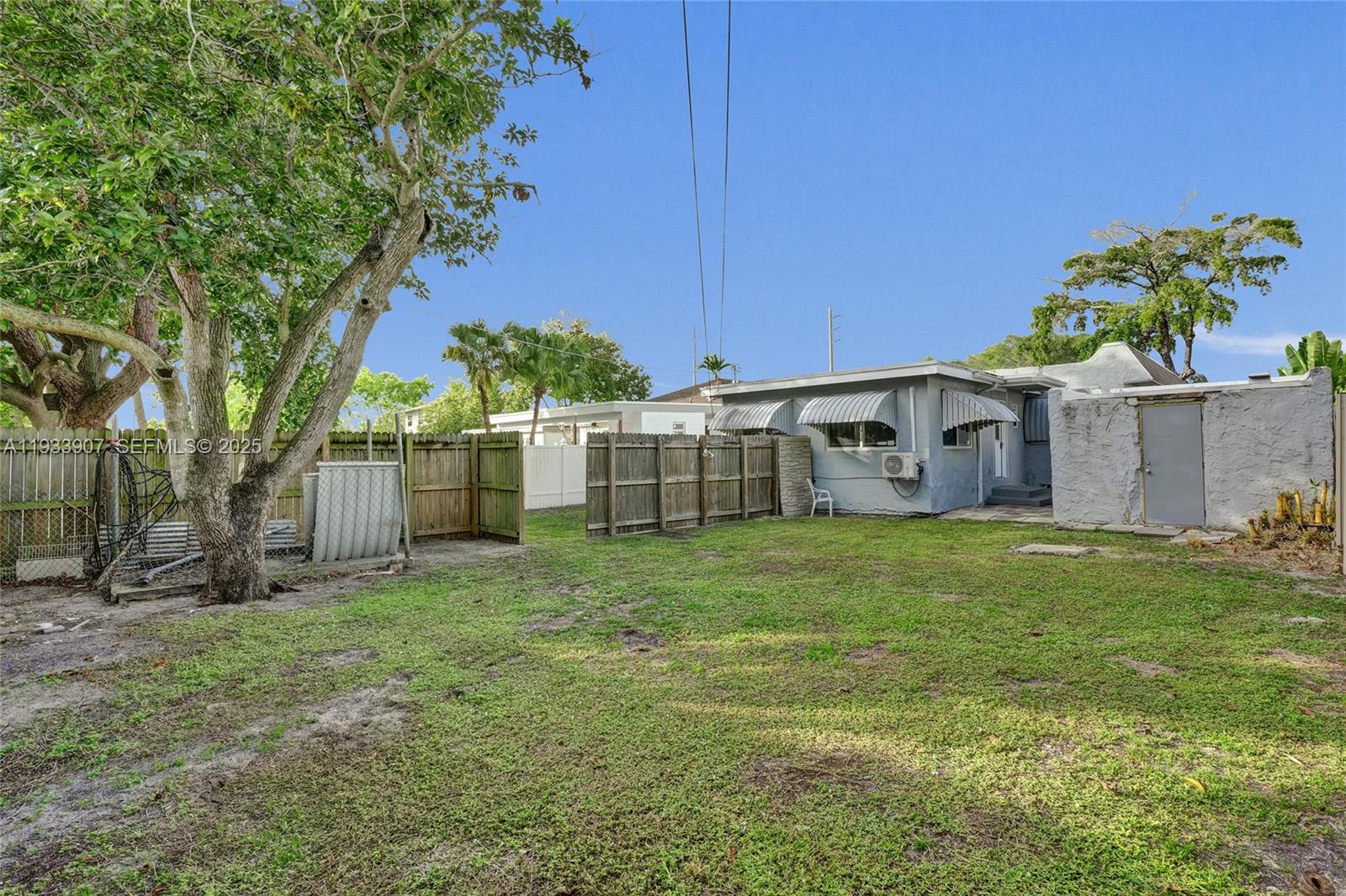 249 Southwest 4th Street, Unit 2 Dania Beach, FL 33004 - Photo 19 of 26 a view of a house with backyard and a tree