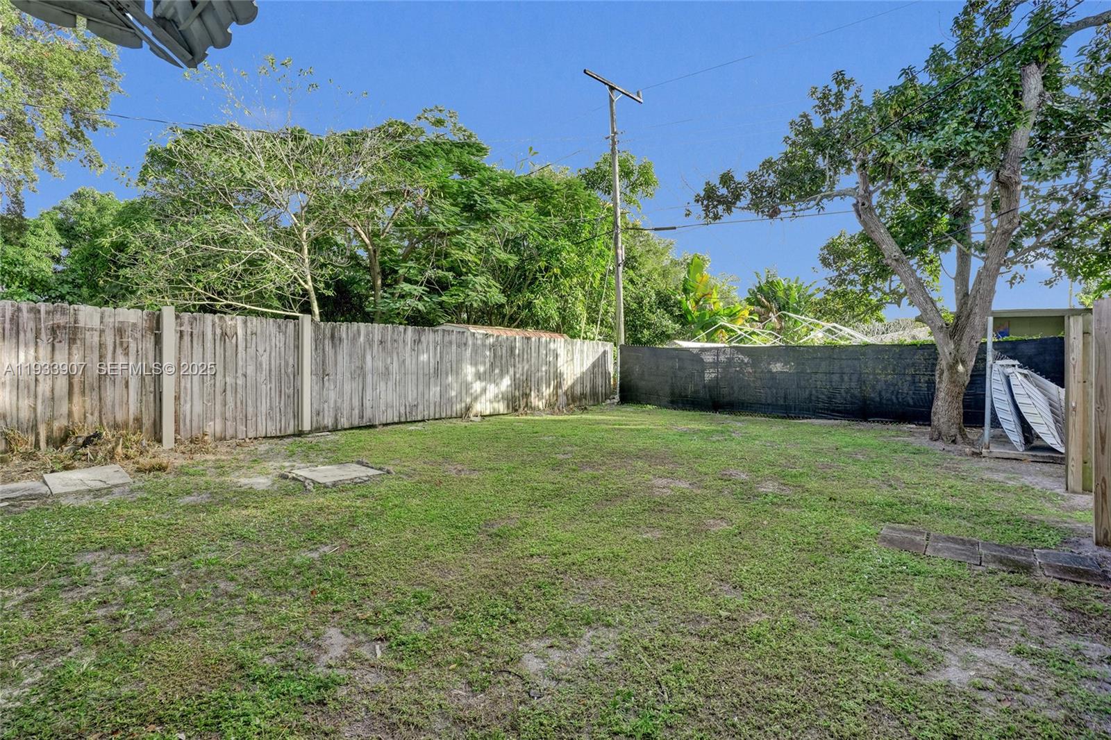 249 Southwest 4th Street, Unit 2 Dania Beach, FL 33004 - Photo 24 of 26 a backyard of a house with lots of green space