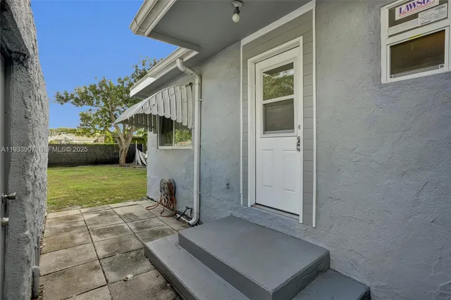 a view of backyard with barbeque grill and stairs