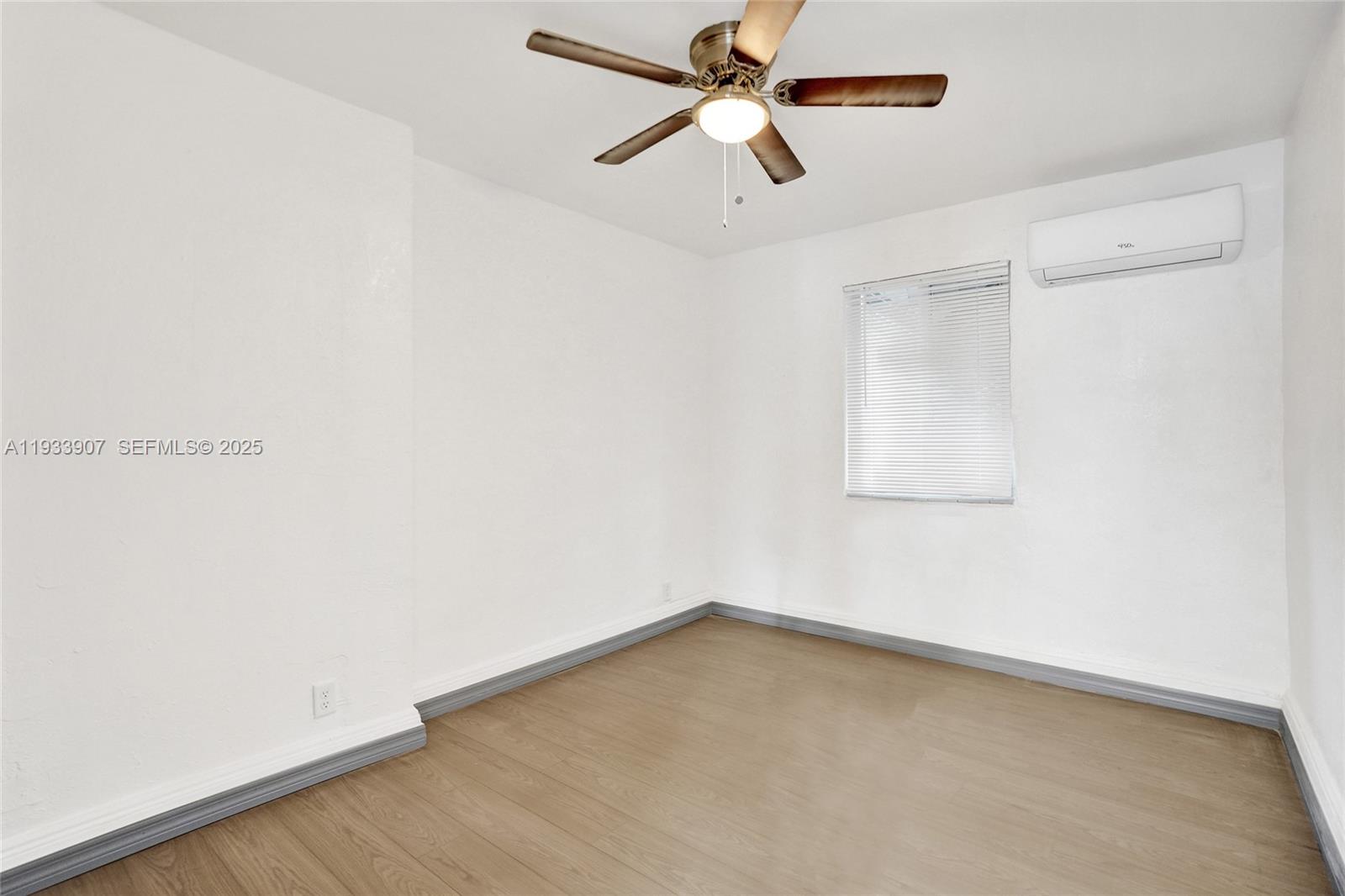 249 Southwest 4th Street, Unit 2 Dania Beach, FL 33004 - Photo 6 of 26 an empty room with a window and a fan