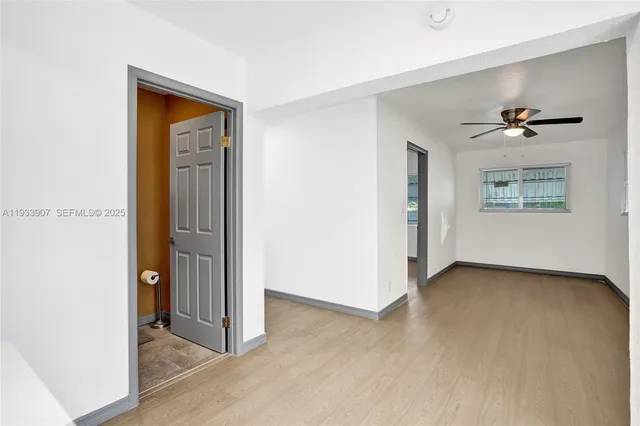 an empty room with windows and closet