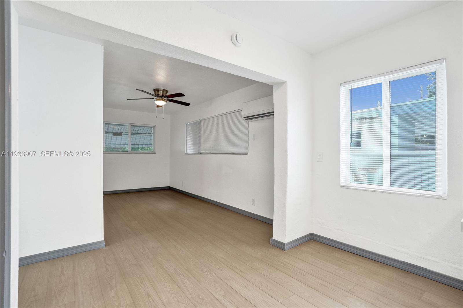 249 Southwest 4th Street, Unit 2 Dania Beach, FL 33004 - Photo 8 of 26 wooden floor in an empty room with a window