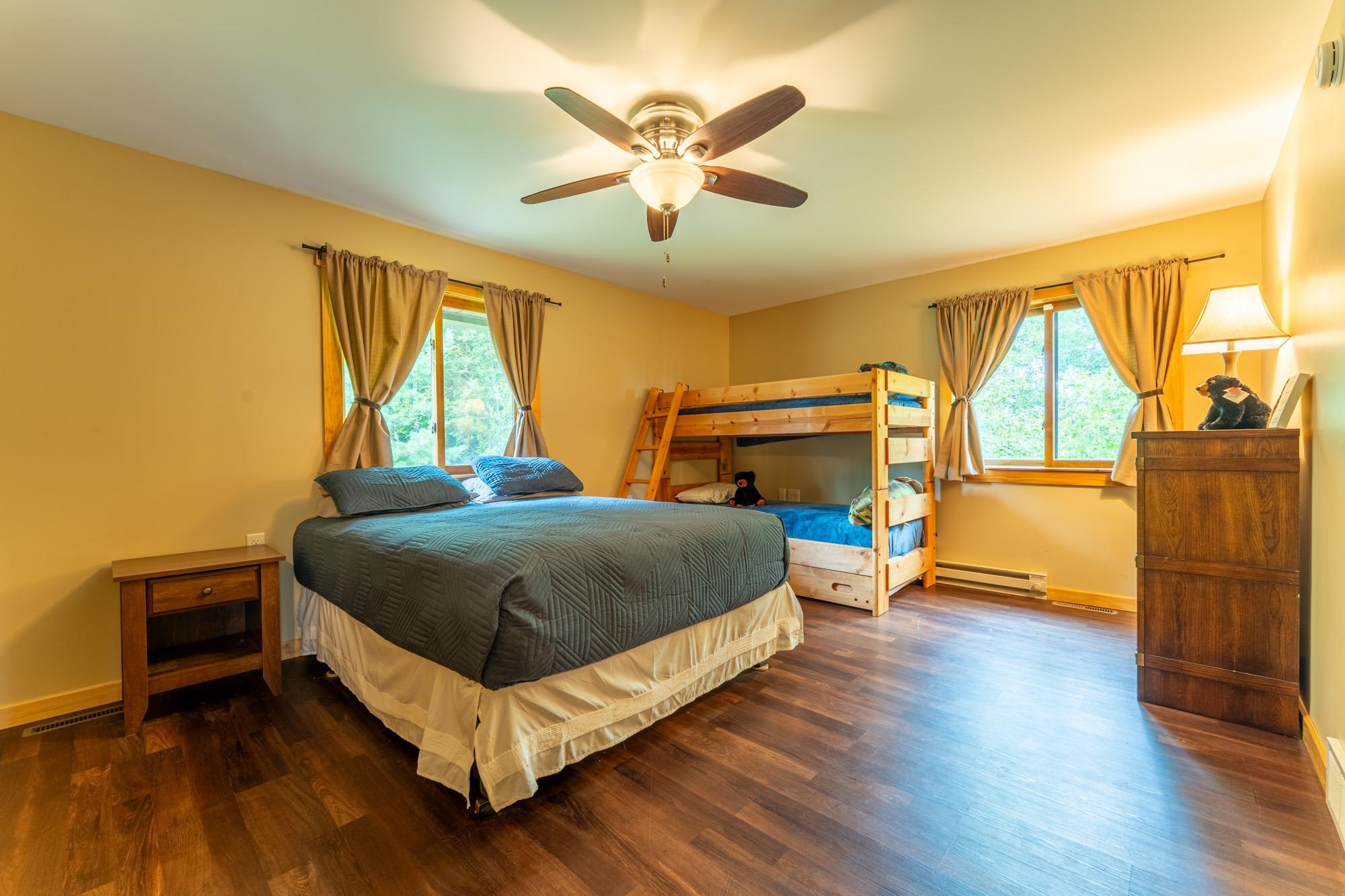 1663 Saari Road Ely, MN 55731 - Photo 15 of 31 Bedroom featuring dark wood-style floors, ceiling fan, and a baseboard radiator