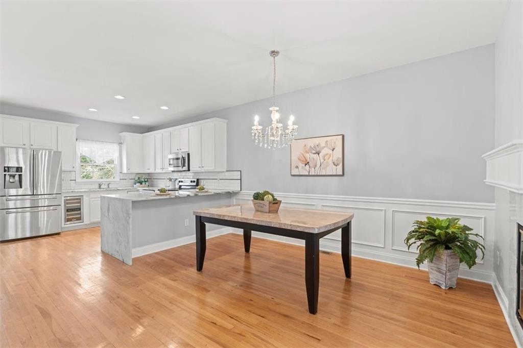 1200 Wing Street, Unit 8 Atlanta, GA 30350 - Photo 16 of 54 a living room with kitchen island furniture and a wooden floor