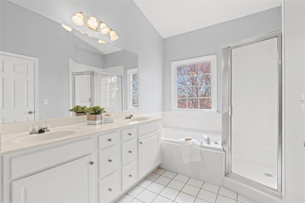 1200 Wing Street, Unit 8 Atlanta, GA 30350 - Photo 22 of 54 a bathroom with a double vanity sink a mirror a bathtub and a vanity