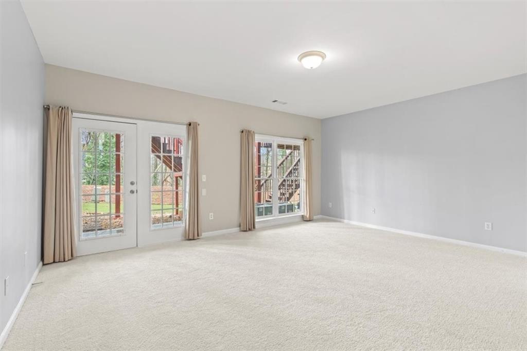 1200 Wing Street, Unit 8 Atlanta, GA 30350 - Photo 24 of 54 a view of an empty room with glass door and balcony
