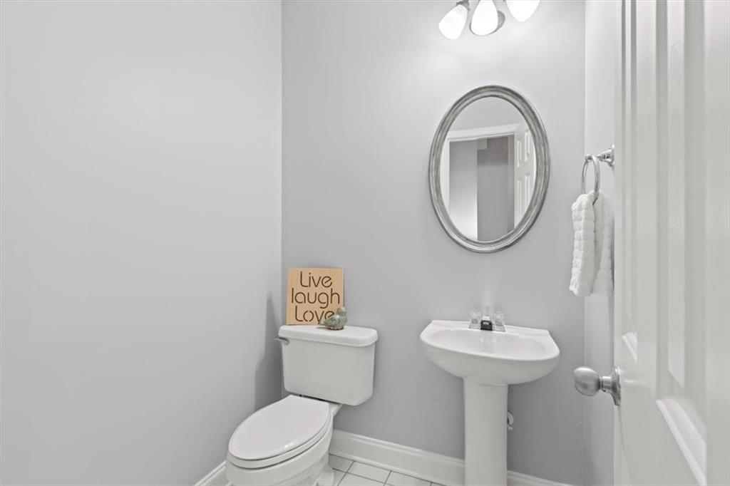 1200 Wing Street, Unit 8 Atlanta, GA 30350 - Photo 30 of 54 a bathroom with a toilet sink and mirror