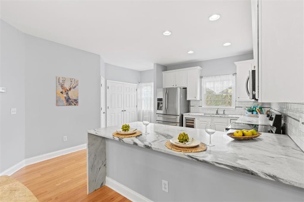1200 Wing Street, Unit 8 Atlanta, GA 30350 - Photo 5 of 54 a kitchen with a sink dishwasher and a stove with wooden floor