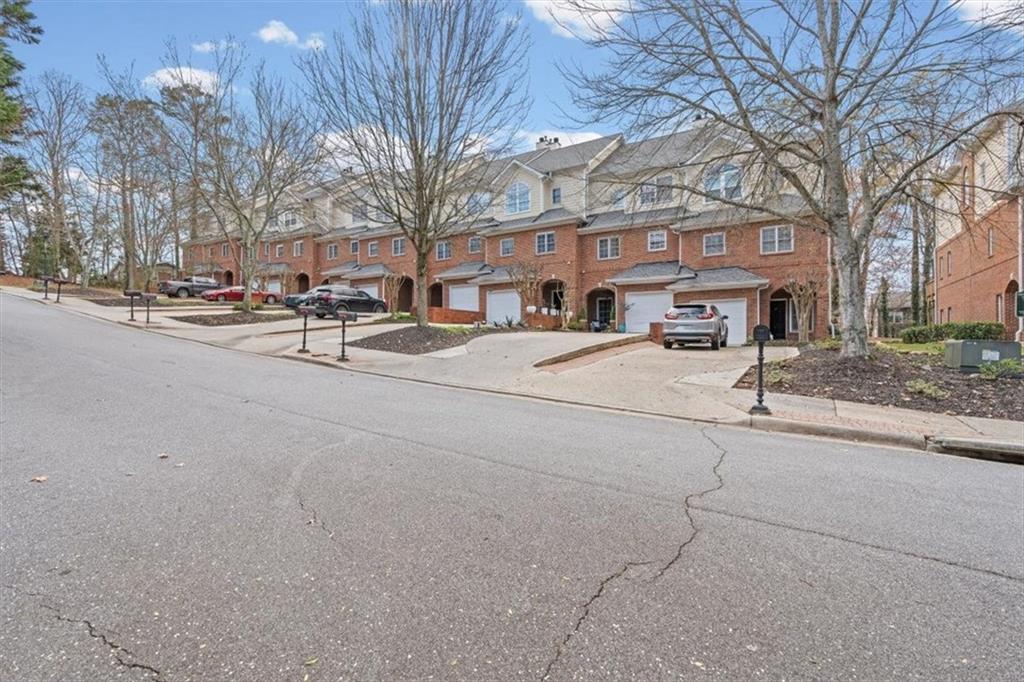 1200 Wing Street, Unit 8 Atlanta, GA 30350 - Photo 51 of 54 a group of cars parked in front of brick building