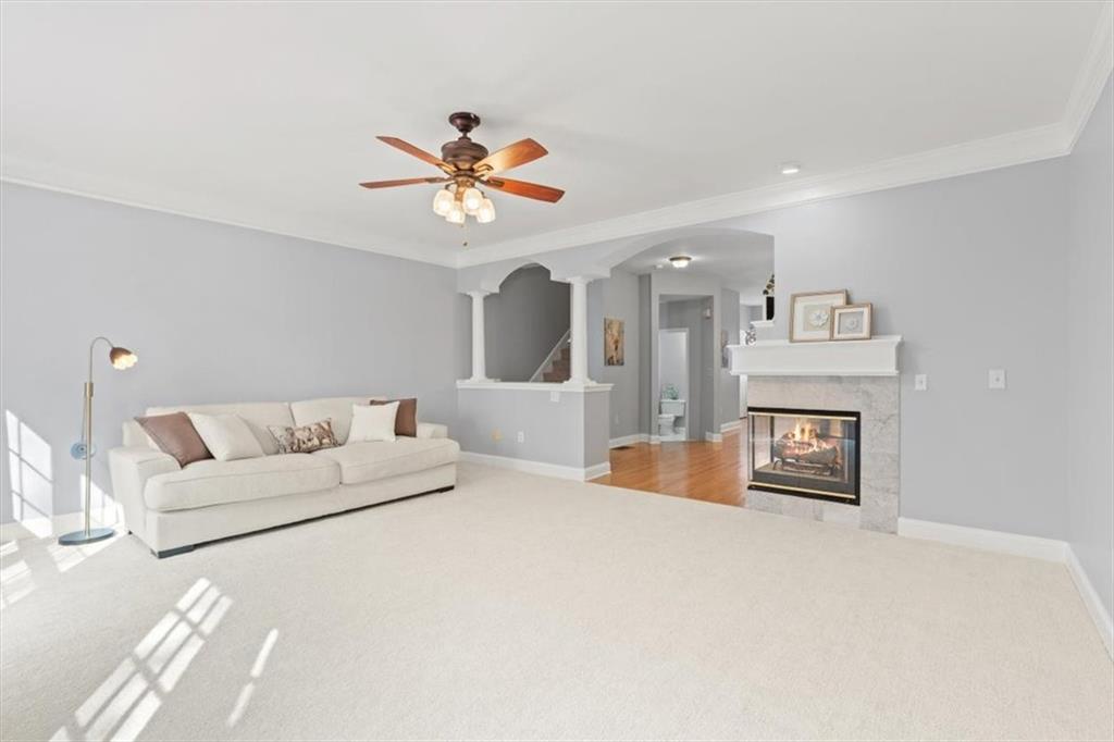 1200 Wing Street, Unit 8 Atlanta, GA 30350 - Photo 6 of 54 a bedroom with a large bed and a chandelier