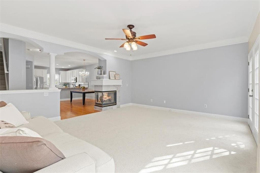 1200 Wing Street, Unit 8 Atlanta, GA 30350 - Photo 10 of 54 a living room with stainless steel appliances furniture a chandelier and a kitchen view