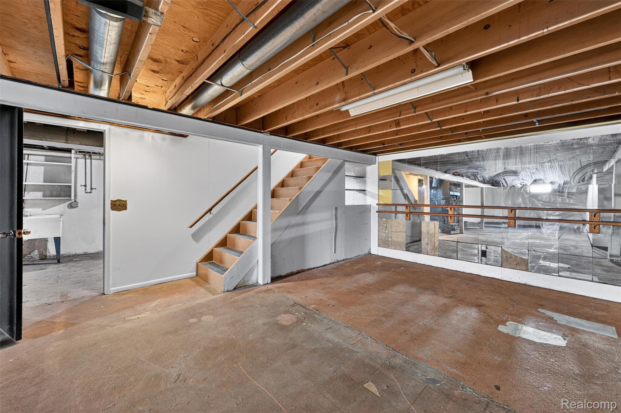 5457 Reid Road Swartz Creek, MI 48473 - Photo 37 of 51 Unfinished basement space featuring exposed wood joists and concrete flooring