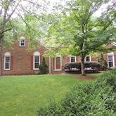 a view of a house with a yard and sitting area
