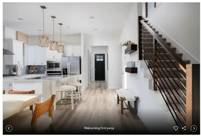 a dining room with furniture a chandelier and window