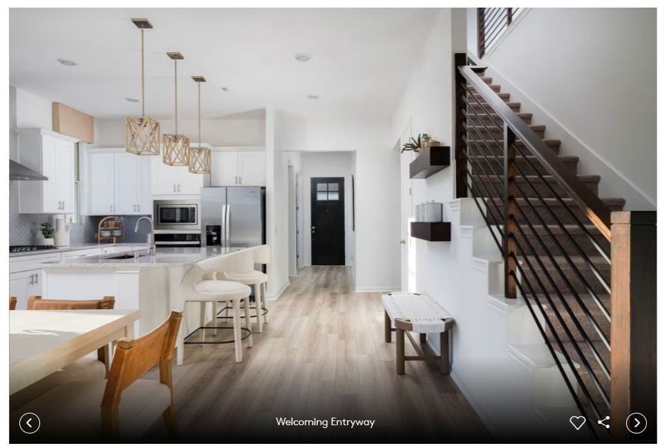 579 Rubber Tree Way Buda, TX 78610 - Photo 4 of 9 a view of a living room and kitchen with furniture wooden floor