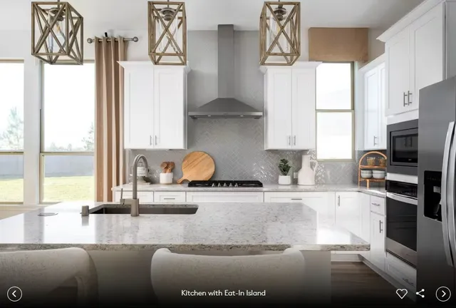 a living room with furniture and a view of kitchen