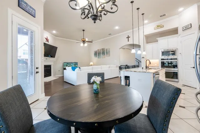 a dining room with furniture and a flat screen tv