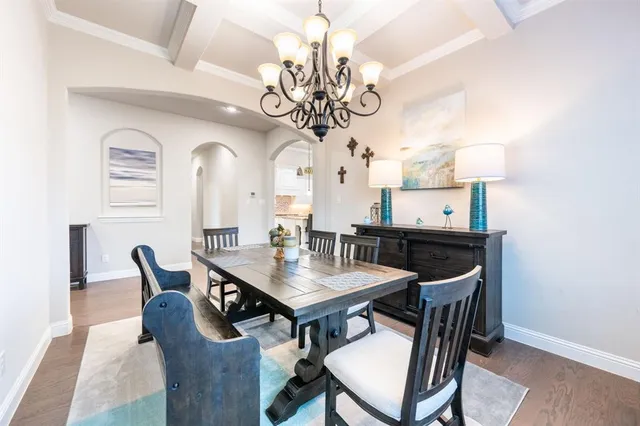 a view of a dining room with furniture and chandelier
