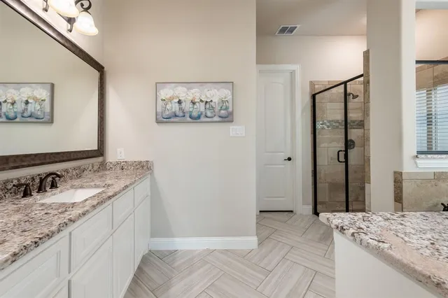 a spacious bathroom with a granite countertop sink