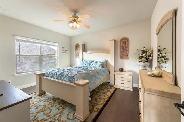 a bedroom with a large bed and a chandelier