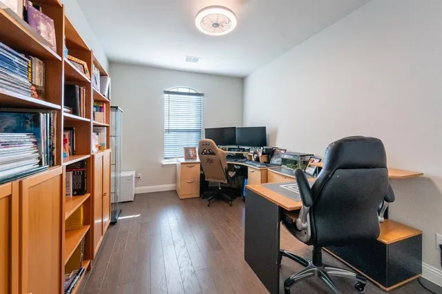 a view of a workspace with furniture and a book shelf