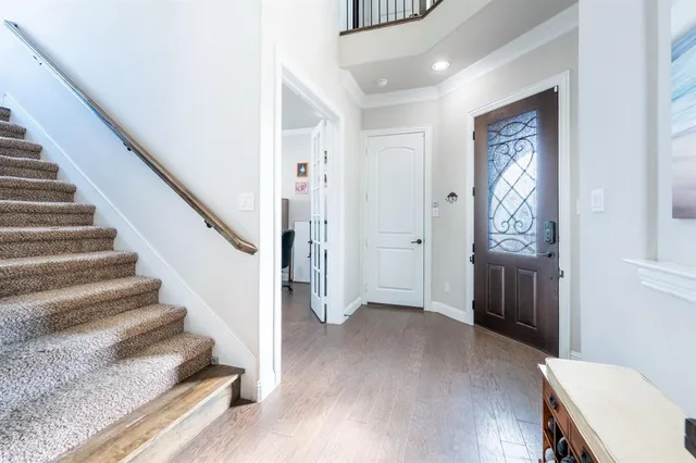 a view of an entryway with wooden floor