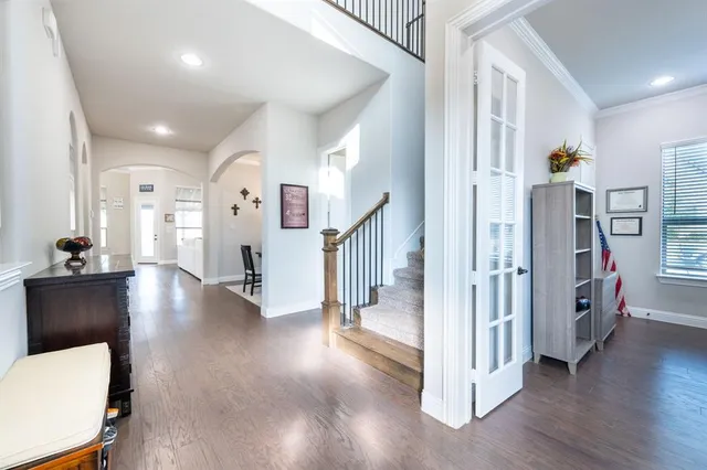 a view of a hallway view with living room and wooden floor