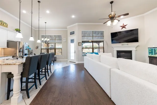 a living room with fireplace furniture and a flat screen tv