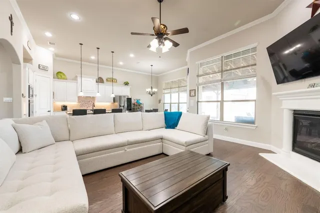 a living room with furniture fireplace and flat screen tv