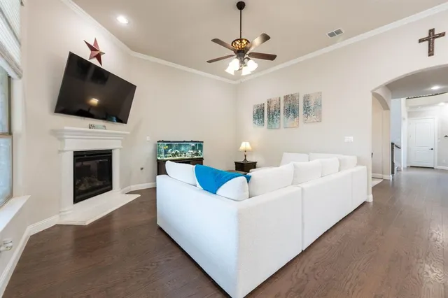 a living room with a fireplace and a flat screen tv