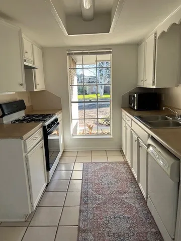 a kitchen with a stove a sink and a refrigerator