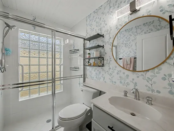a bathroom with a sink toilet and shower