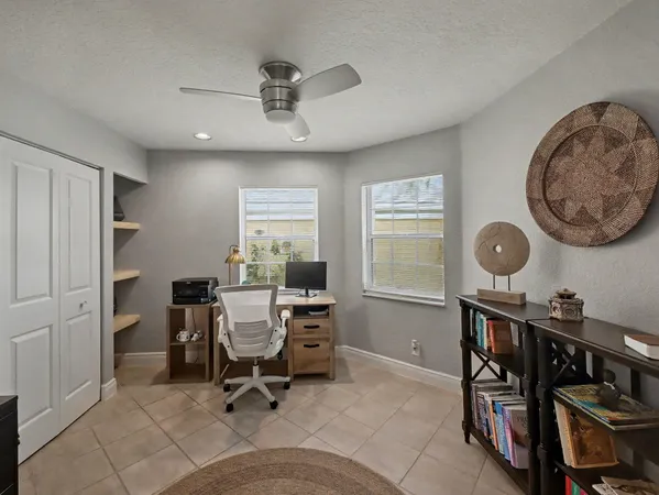 a view of a workspace with furniture and a window