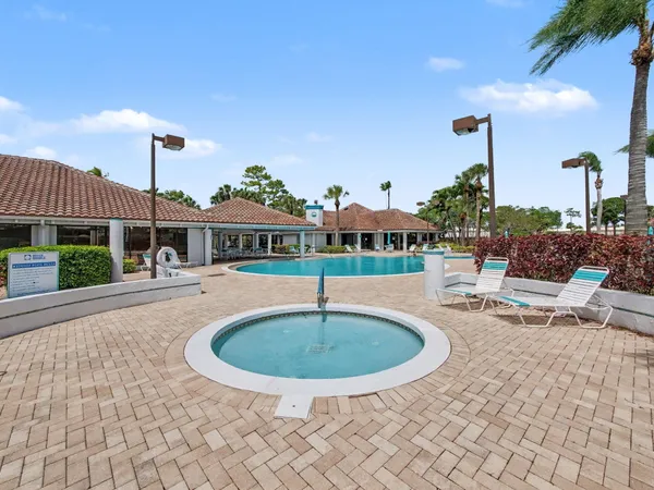 a view of a house with swimming pool and sitting area