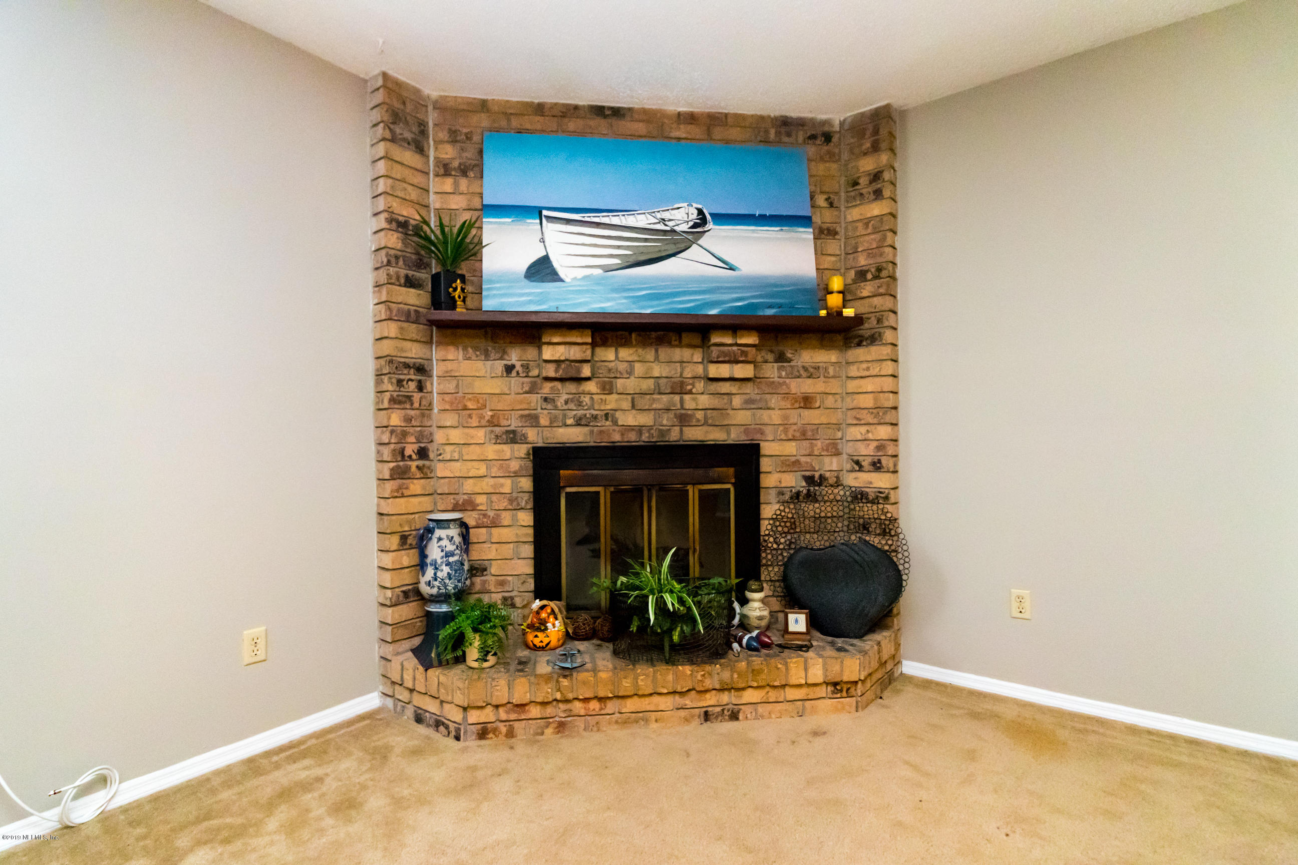 508 Penman Road Neptune Beach, FL 32266 - Photo 6 of 32 a view of a fireplace with potted plants in front of door