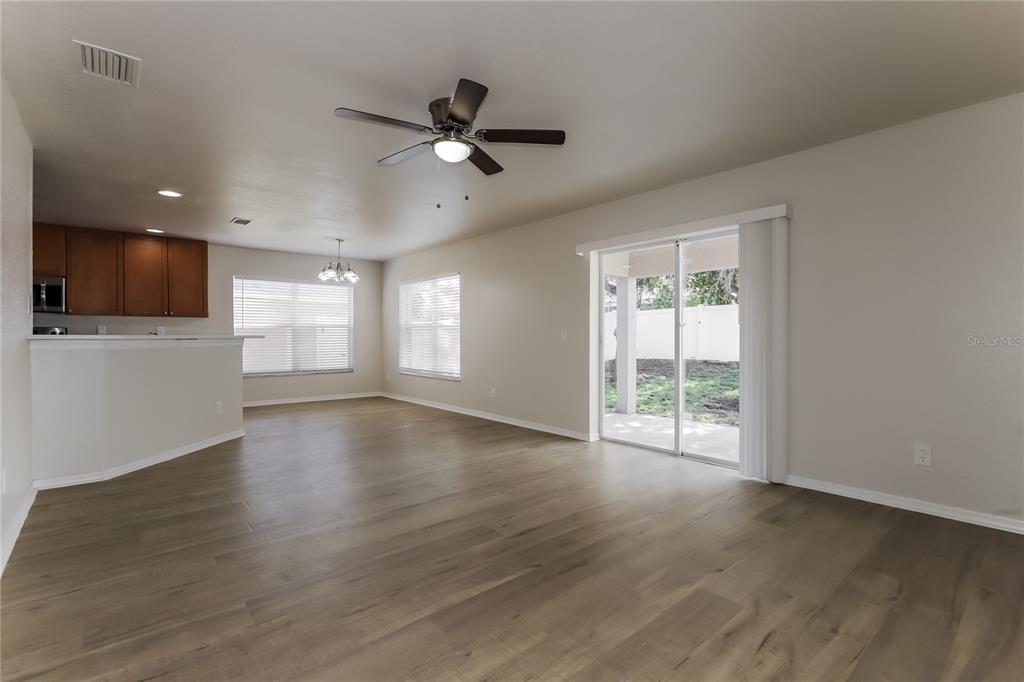 11420 Bay Gardens Loop Riverview, FL 33569 - Photo 2 of 17 a view of an empty room with a window and wooden floor