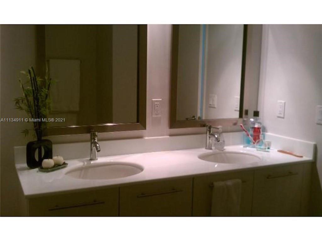 92 Southwest 3rd Street, Unit 3808 Miami, FL 33130 - Photo 12 of 15 a bathroom with a sink and a mirror
