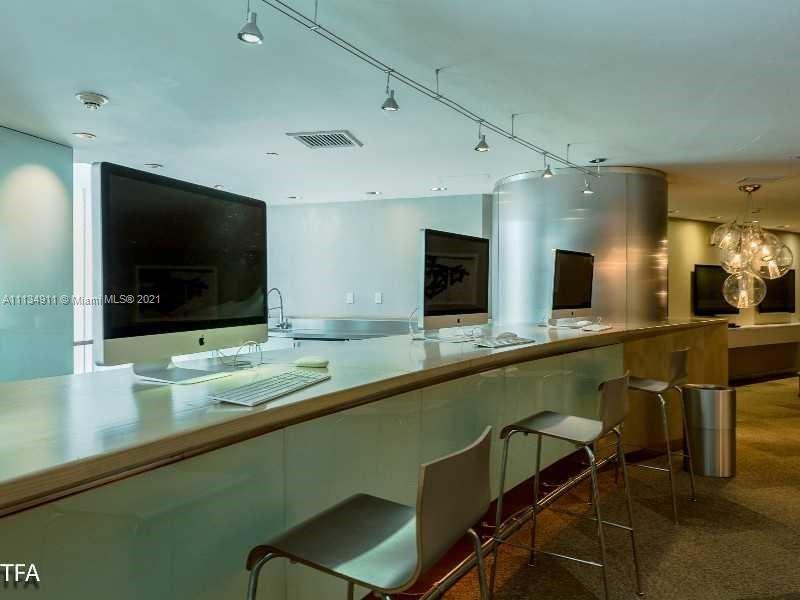 92 Southwest 3rd Street, Unit 3808 Miami, FL 33130 - Photo 6 of 15 a kitchen with a table chairs sink and microwave