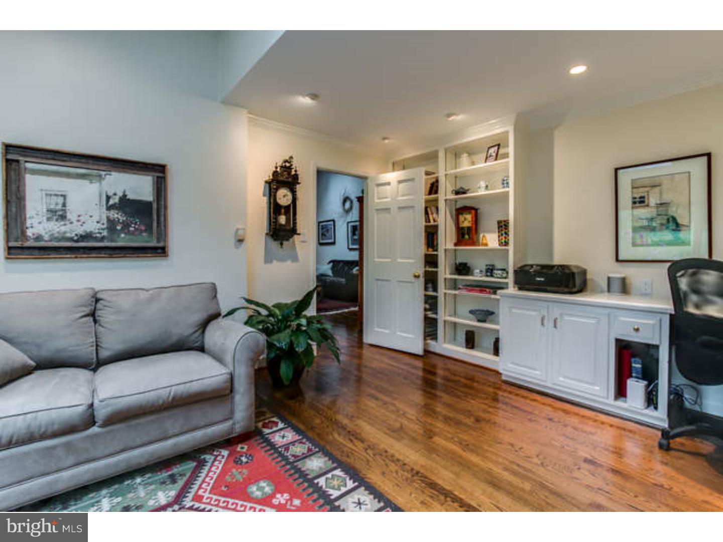 8 Squirrel Run Greenville, DE 19807 - Photo 13 of 24 a living room with furniture and kitchen view with wooden floor