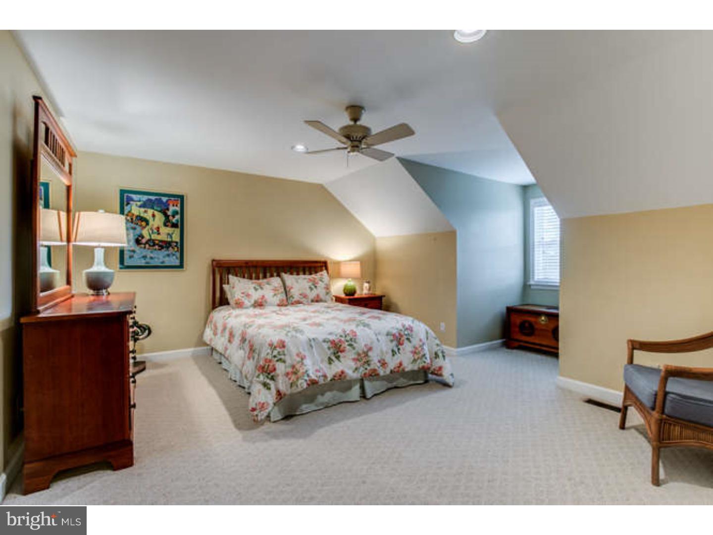 8 Squirrel Run Greenville, DE 19807 - Photo 18 of 24 a spacious bedroom with a bed and a chandelier