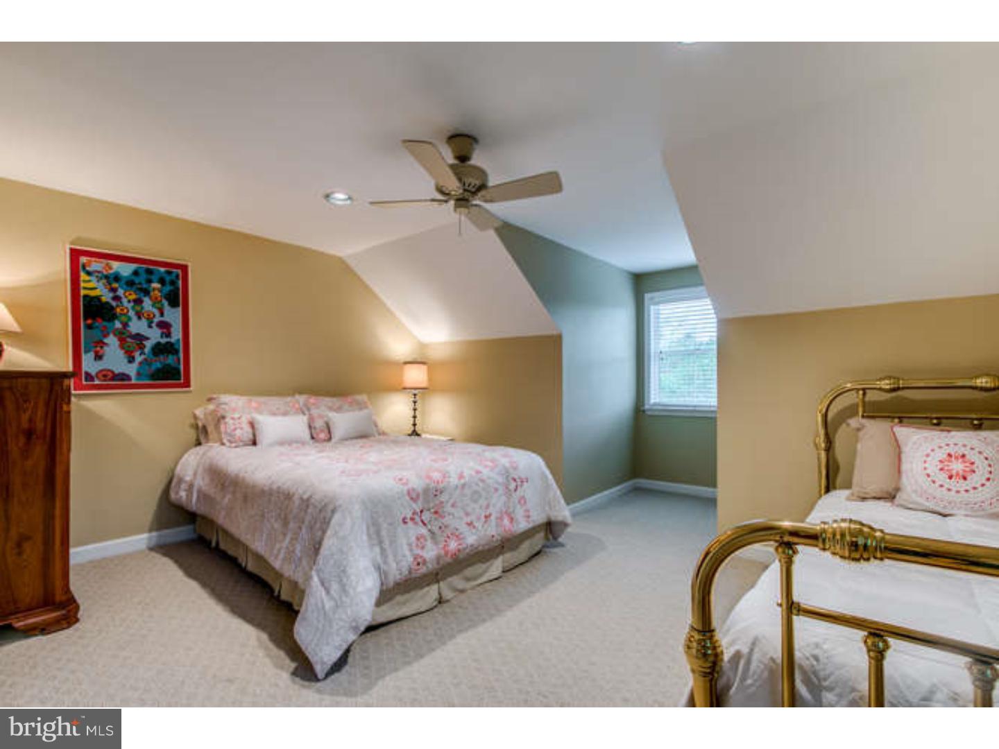 8 Squirrel Run Greenville, DE 19807 - Photo 21 of 24 a bedroom with a bed and a painting on the wall