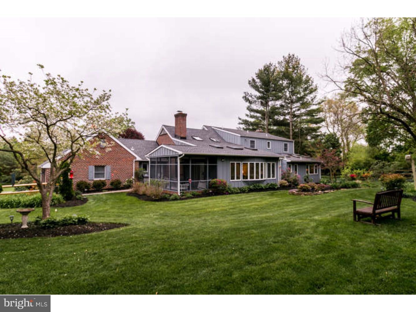 8 Squirrel Run Greenville, DE 19807 - Photo 23 of 24 a view of a big house with a big yard and potted plants and large trees