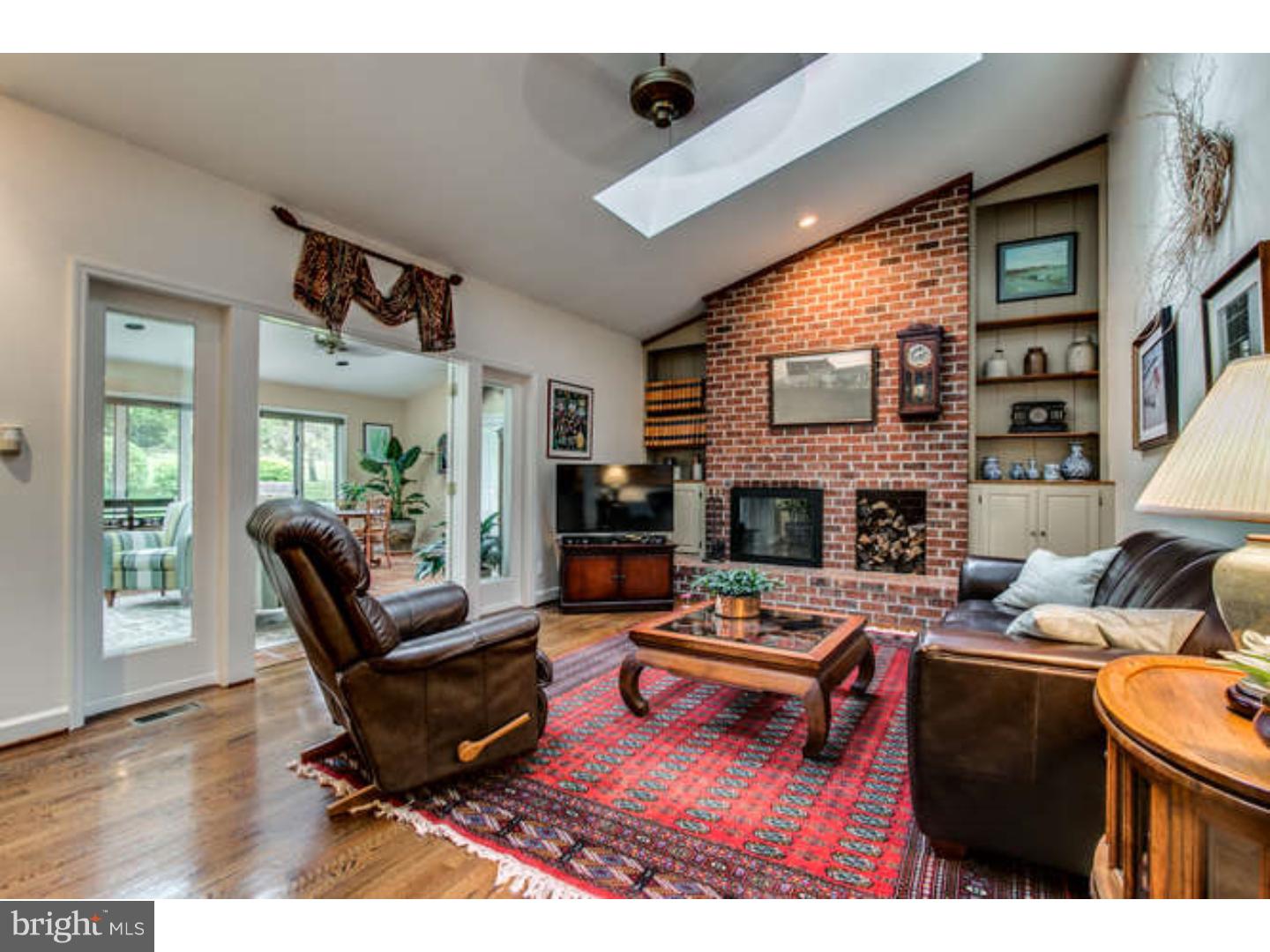 8 Squirrel Run Greenville, DE 19807 - Photo 9 of 24 a living room with furniture flat screen tv and a fireplace