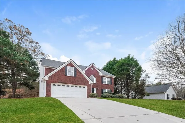a front view of a house with a yard and garage