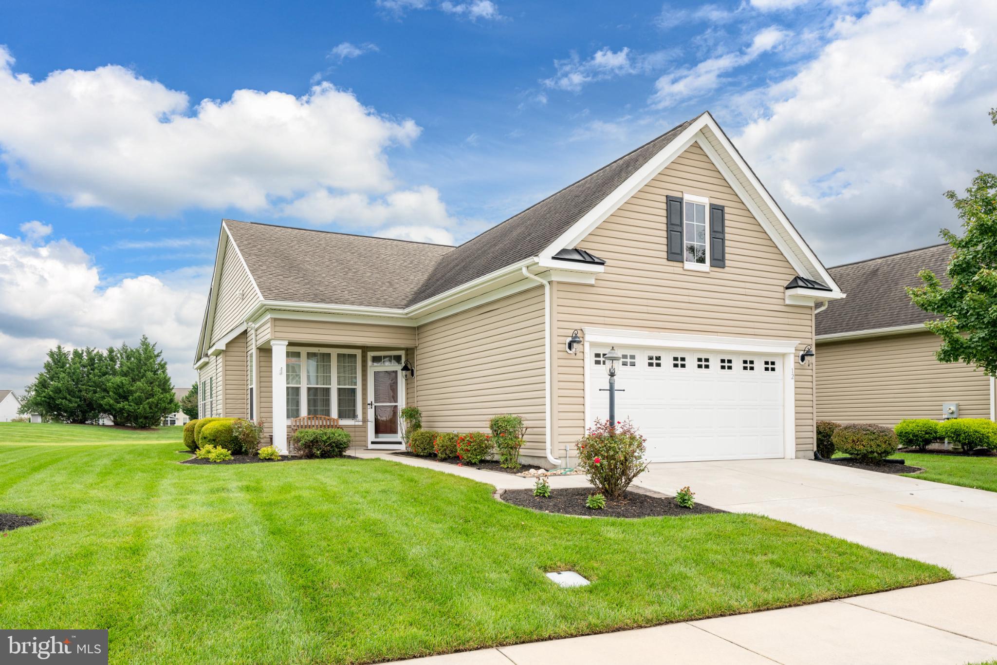 Charming home with lush green surroundings.